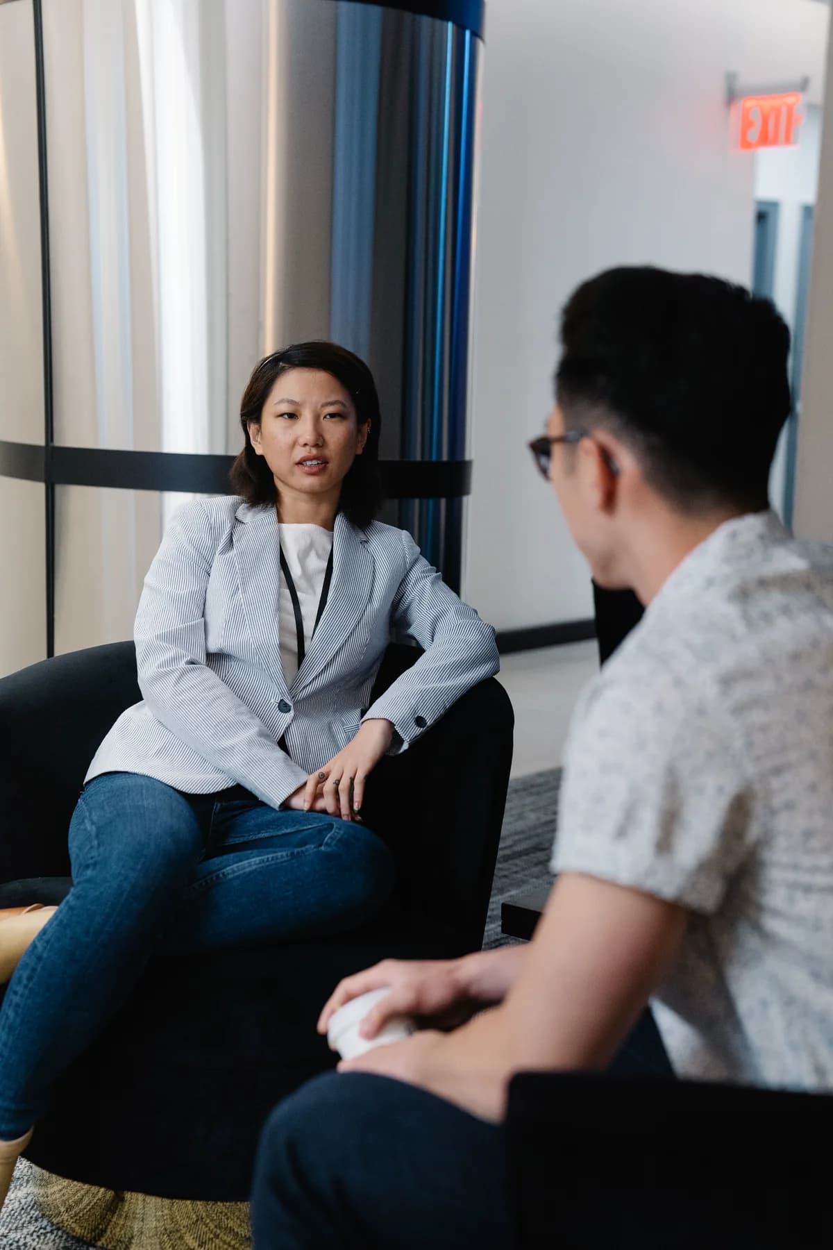 Two business professionals in a focused office conversation