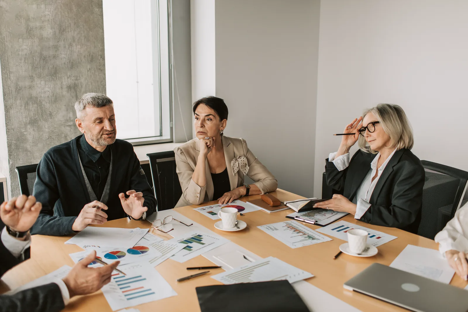 Business leaders reviewing operating data around a meeting table